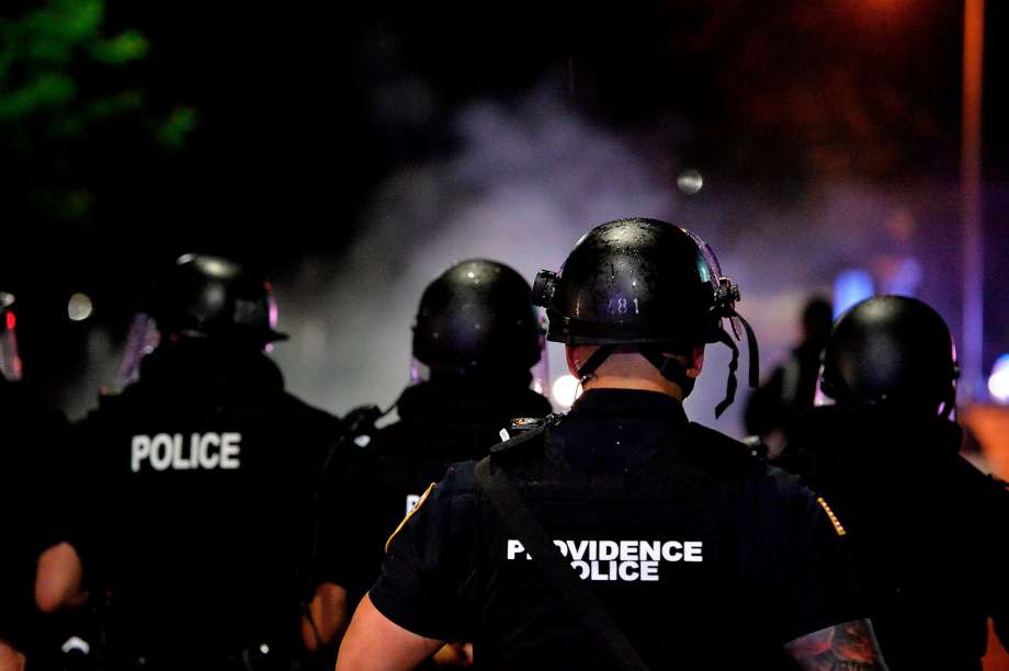 Police officers and National Guard soldiers make their way through a smoke filled street as they chase and confront protesters after curfew and after a peaceful Black Lives Matter rally in Providence, Rhode Island on June 5, 2020. (Photo by Joseph Prezioso / AFP) (Photo by JOSEPH PREZIOSO/AFP via Getty Images) Photo: Joseph Prezioso, AFP Via Getty Images